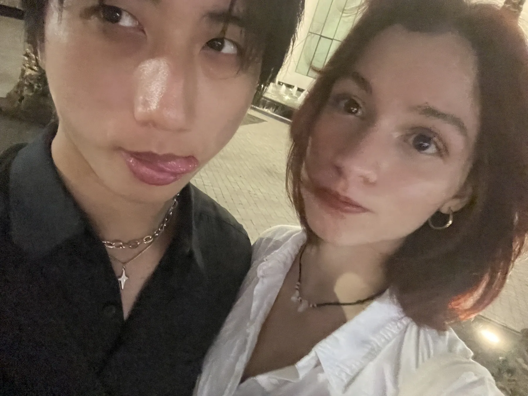Chris and his partner taking a close late-night selfie outdoors