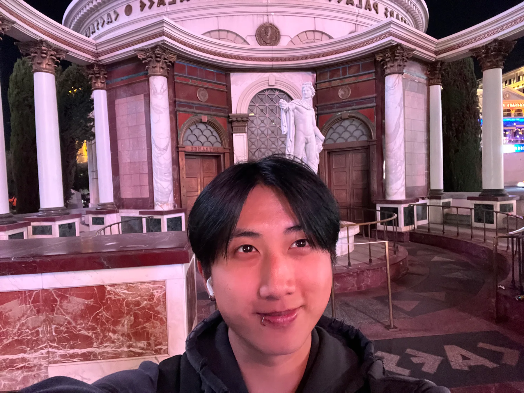 Chris taking a nighttime selfie in front of an ornate building